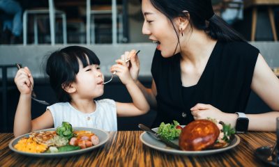 A woman and child eating food.