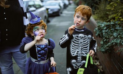Young kids enjoying candy on Halloween.
