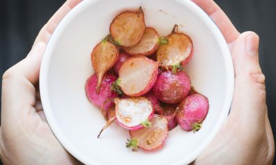 Bowl of red potatoes garnished with an herb