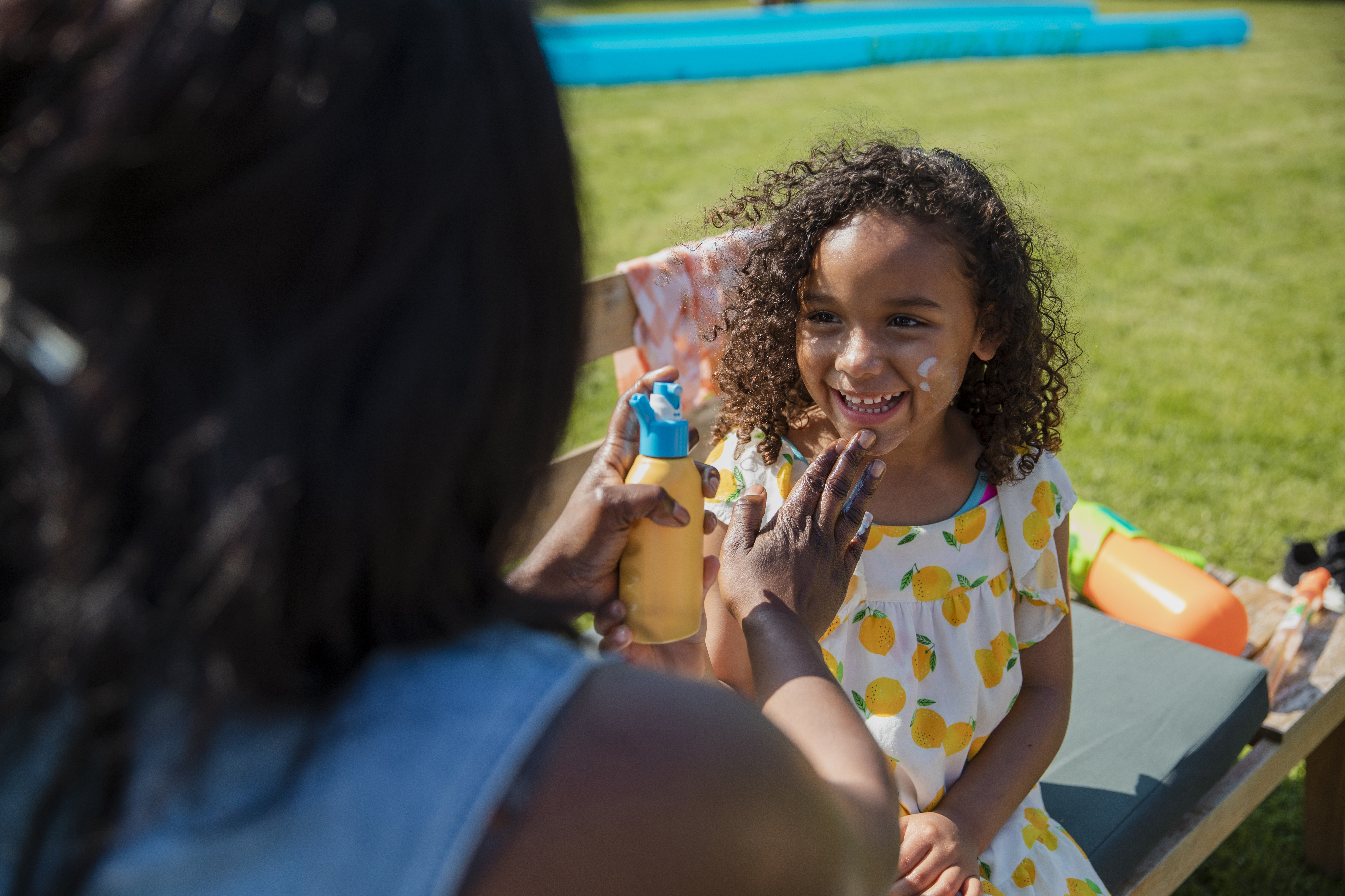 Woman applying sunscreen to a kid