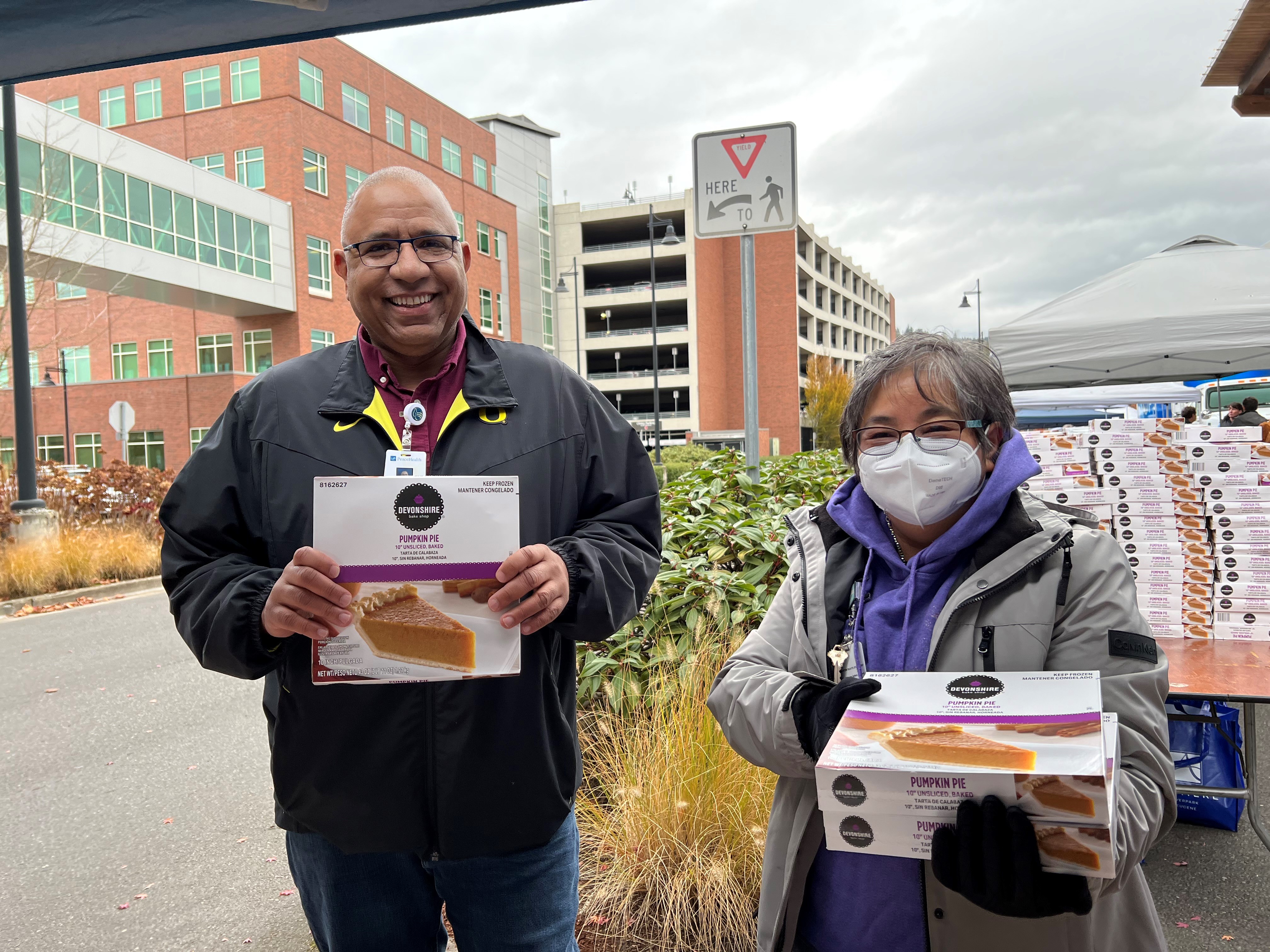 PeaceHealth caregivers hold pumpkin pies included in 800 Thanksgiving Baskets for local families in need
