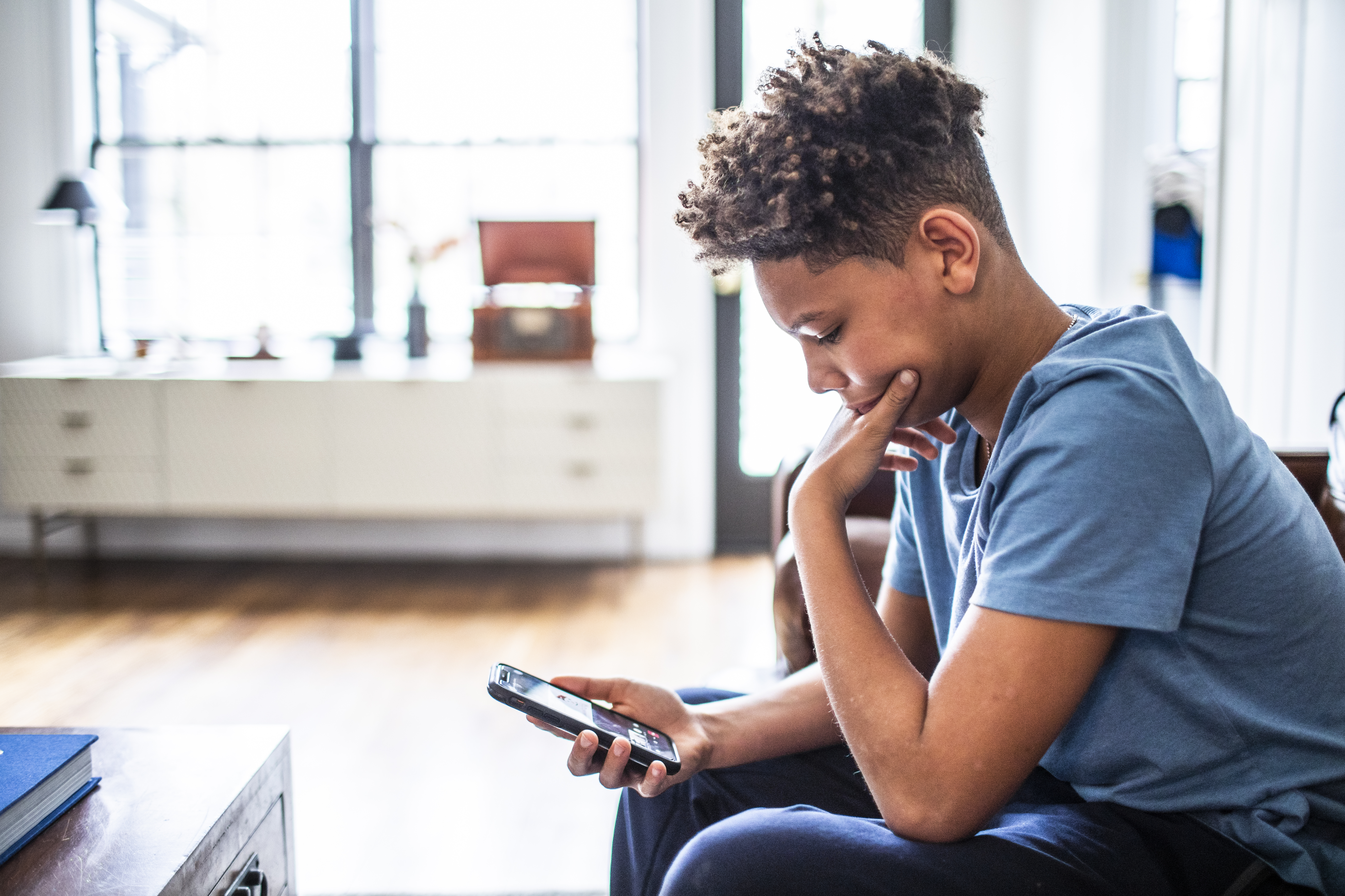 Teenage boy looking at phone.