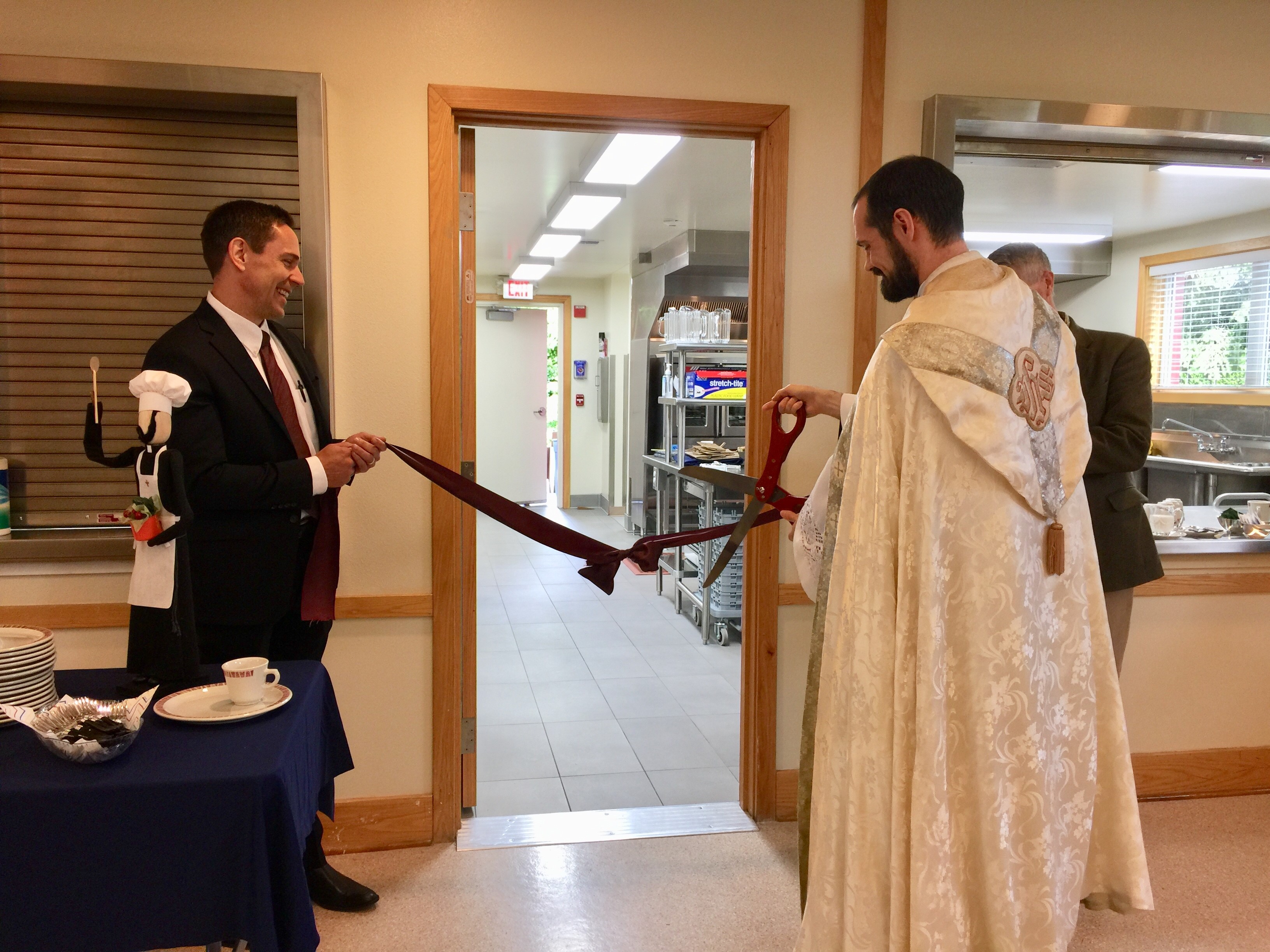 Todd Salnas and Fr. Mark Bentz in ribbon cutting ceremony