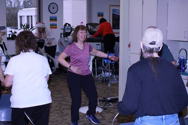 A woman exercising in a room with gym equipment