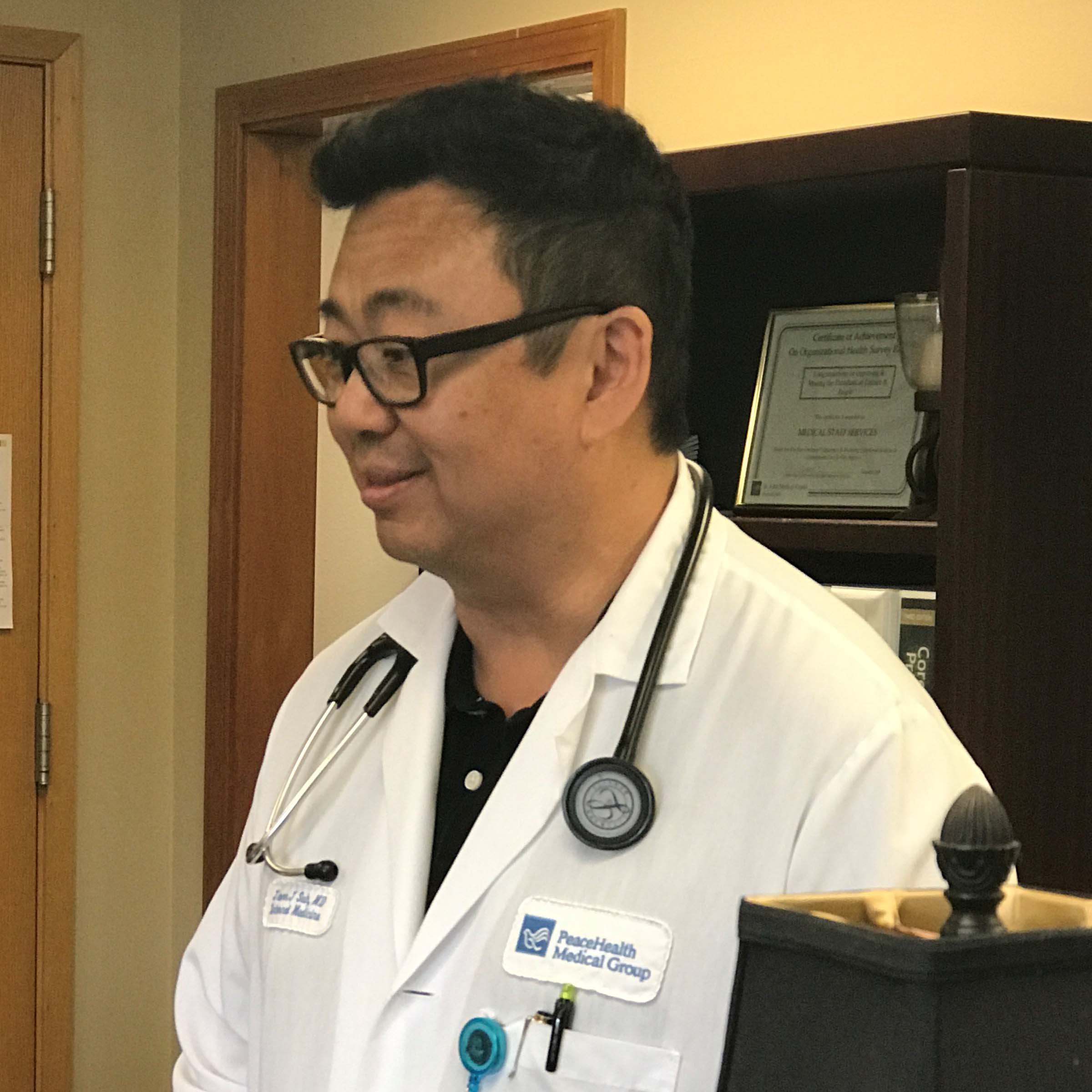 Dr. Jason Suh smiles at something off camera