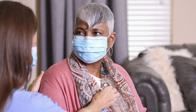 Healthcare worker listens to a woman