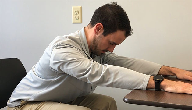 Patrick from physical therapy at PeaceHealth stretches his upper back