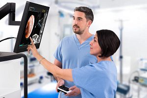 Two health care providers review and discuss a patient's imaging scan