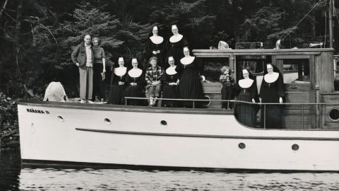 Several sisters ride on a boat with others.