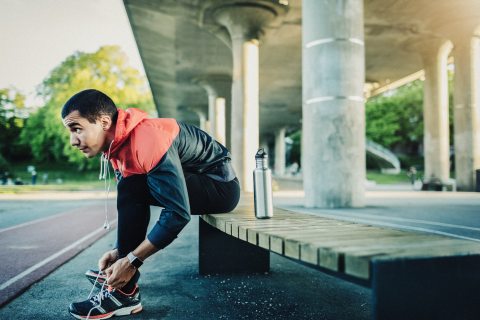 Man tying shoes to go running
