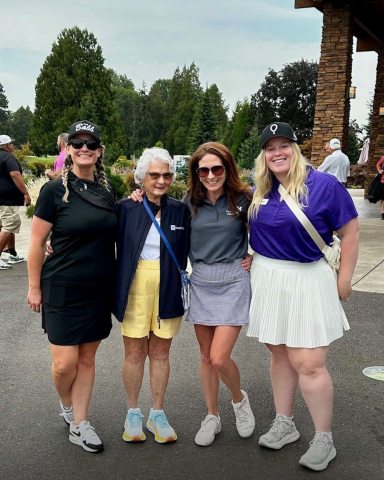 4 women standing and smiling at the camera while at the CMN golf tournament