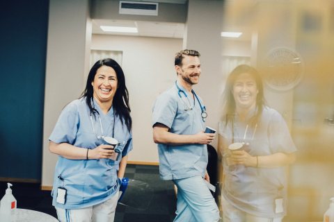 Two medical professionals smiling at the camera