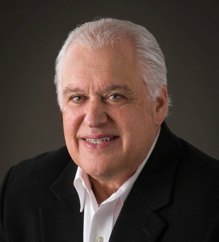 John Huntley smiling at the camera