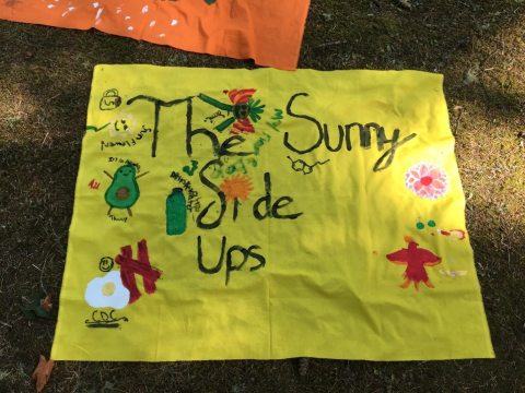 A handmade sign that reads "the sunny side ups" along with drawings
