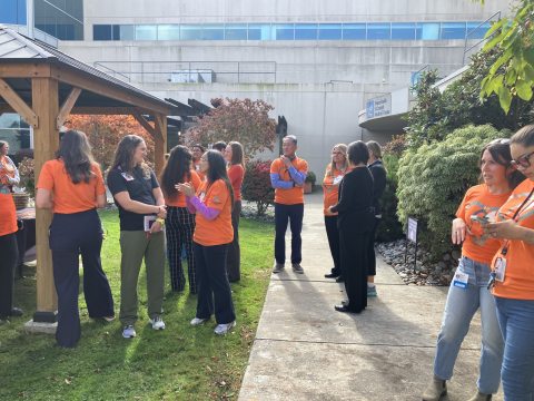 Orange T-shirt group near walkway