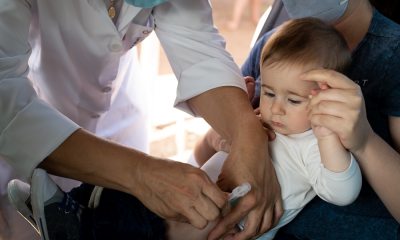 A child receives a vaccination from a healthcare provider