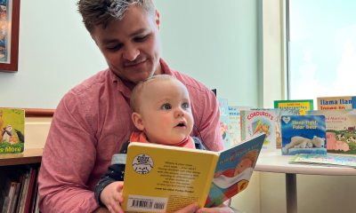 Father reads to his infant son