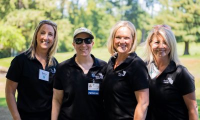 4 women in black peacehealth shirts smiling at the camera