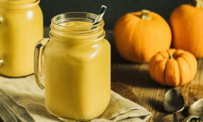 pumpkin smoothie in a glass with a paper straw
