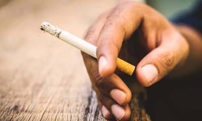 Close-up of a hand holding a lit cigarette