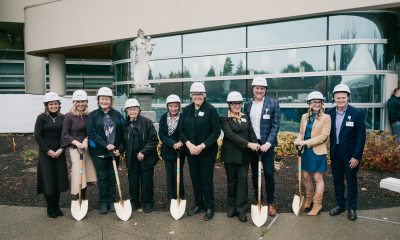 A group of people holding shovels and wearing hard hats ready to "break ground" on the peter paulsen pavilion