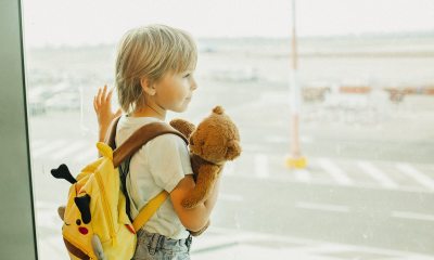 Young child looks out window at airport