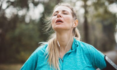 Exhausted runner with eyes closed, face tilted up
