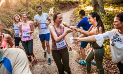 Volunteers hand out water to passing runners