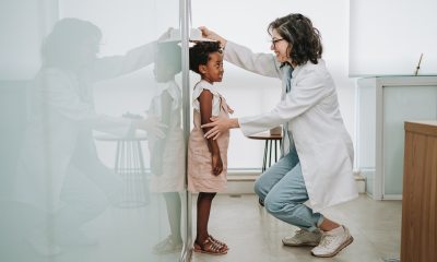 Physician measuring a child's height