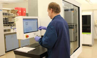 A caregiver uses a piece of lab equipment to test a specimen at the RiverBend Annex.