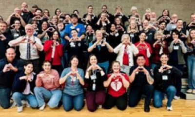 North Eugene High School student group picture with all holding hands in a heart shape