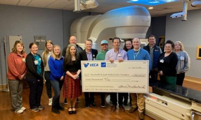 Veca presenting a check to United General's cancer center