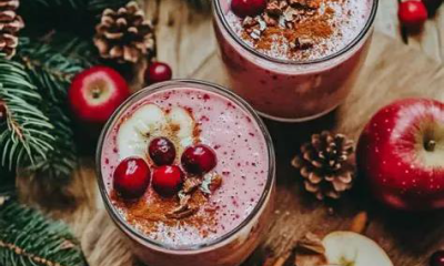 Festive looking, but healthy holiday shakes surrounded by fruits and elements of pine trees