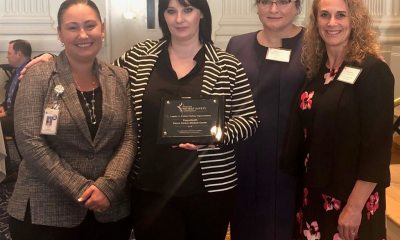 A group of four Peace Harbor PeaceHealth employees accepting an award