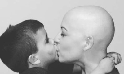 Black and white photo of Chelsea Nelson and son kissing