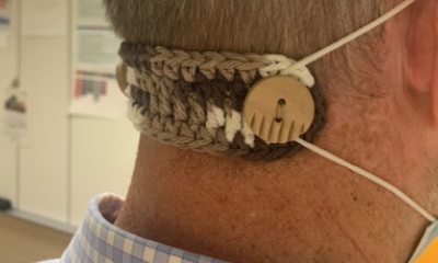 the back of a person wearing a crocheted ear saver and mask