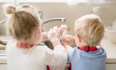 Kiddos washing hands at kitchen sink