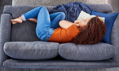young woman lying on couch