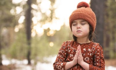 young girl outside praying