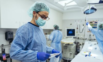 Doctor holds an IV bag in a procedure room