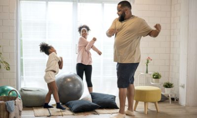 Father exercises with young daughters