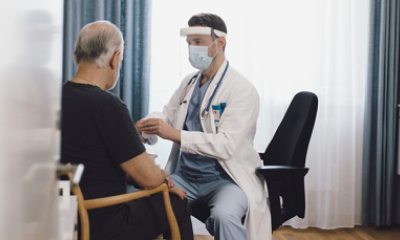 Doctor talks to a man in an exam room