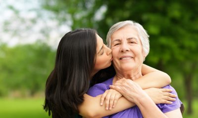Young woman hugs an older woman from behind
