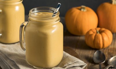 pumpkin smoothie in a glass with a paper straw
