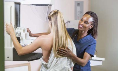 mammography technician helps young woman get mammogram