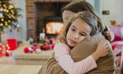 Sad young girl hugging her mom during the holidays