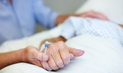 Health care provider or family member holding a patient's hand