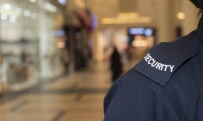 Close-up of security guard's shoulder with the word "security" on a patch