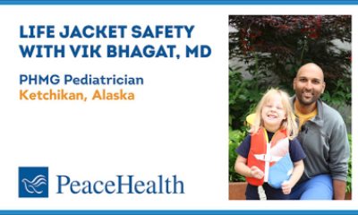 Dr. Vik Bhagat and a young helper demonstrate basics on life jackets