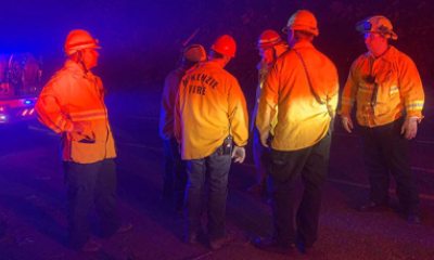Firefighters consult about the Holiday Farm fire